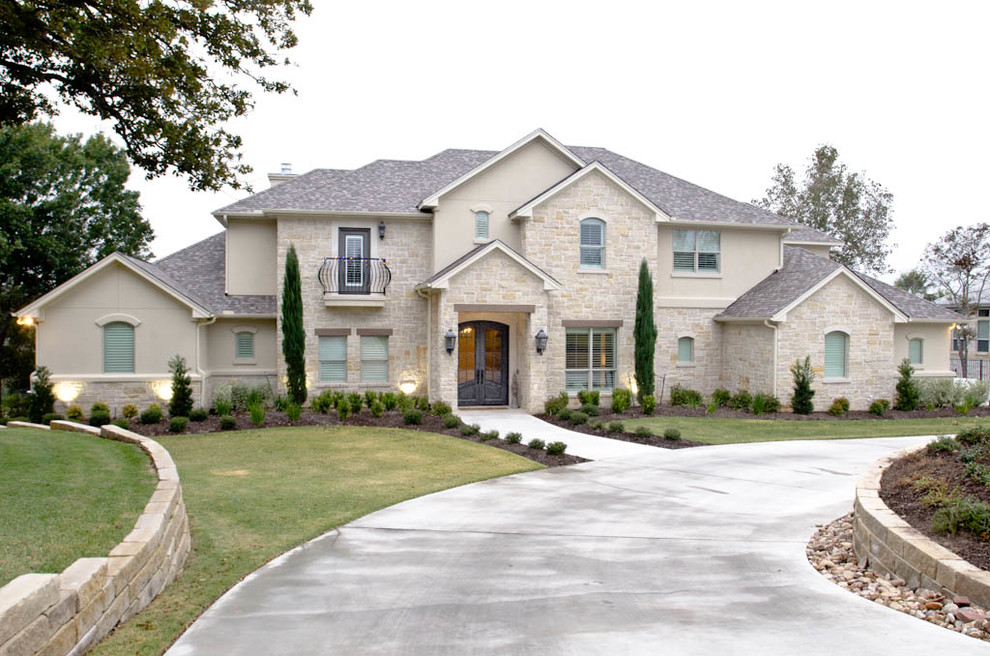 Design ideas for an expansive traditional two-storey beige exterior in Austin with stone veneer and a gable roof.