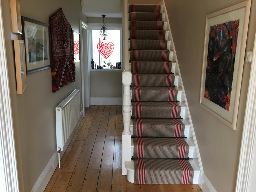 Photo of a mid-sized traditional wood l-shaped staircase in Hampshire with wood risers and wood railing.