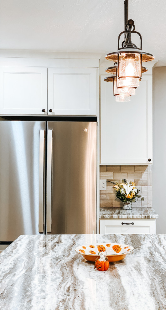 Kitchen - transitional l-shaped light wood floor and beige floor kitchen idea in Columbus with an undermount sink, white cabinets, gray backsplash, an island and gray countertops