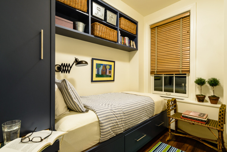 Photo of a small transitional kids' room for boys in New York with blue walls and medium hardwood floors.