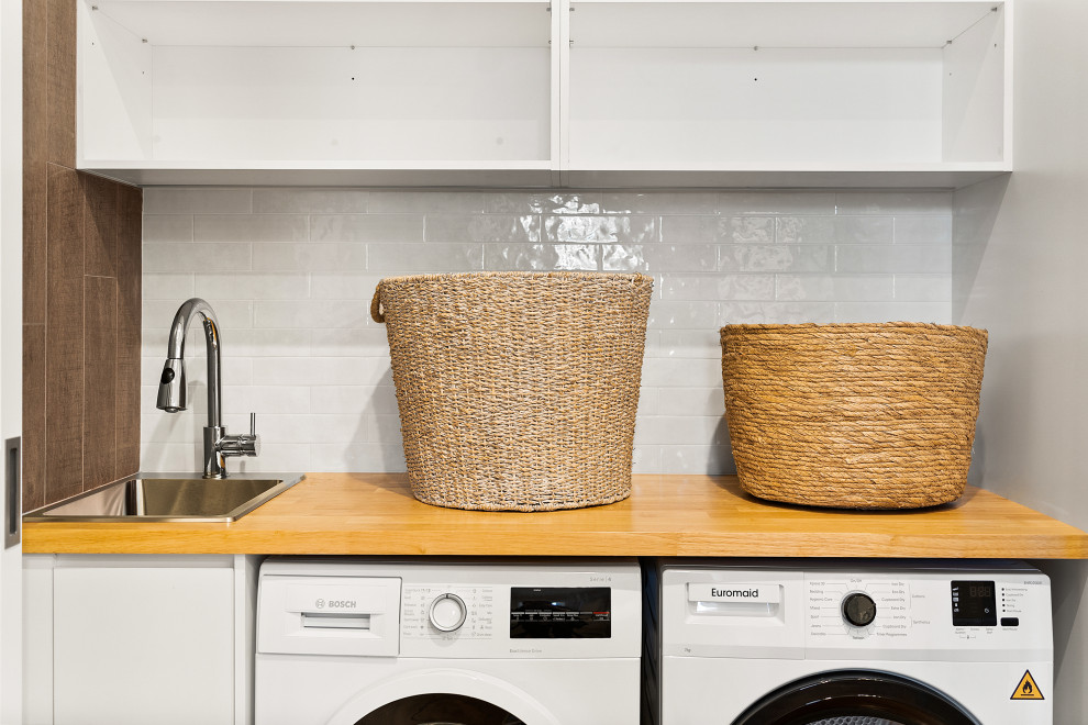 Transitional laundry room in Sydney.