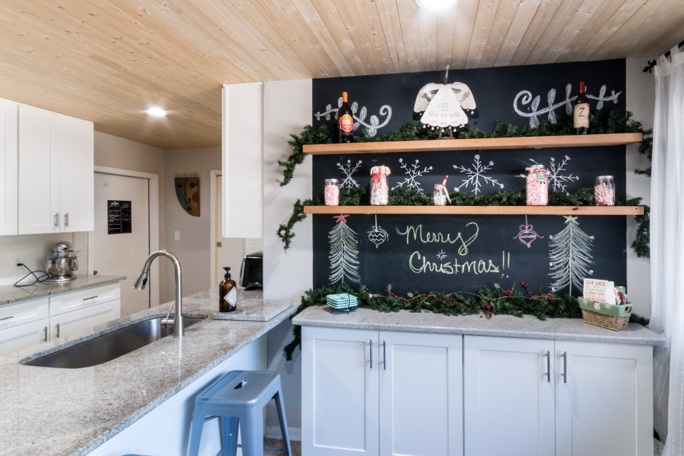 Eat-in kitchen - small transitional cement tile floor and brown floor eat-in kitchen idea with an undermount sink, shaker cabinets, white cabinets, granite countertops, white backsplash, cement tile backsplash, stainless steel appliances, a peninsula and white countertops