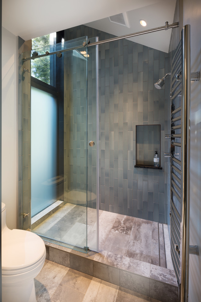 This is an example of a contemporary master bathroom in San Francisco with an open shower, blue tile, ceramic tile, ceramic floors and a sliding shower screen.