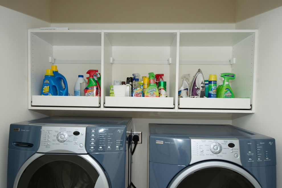 Photo of a small country single-wall laundry cupboard in Other with open cabinets, white cabinets, white walls and a side-by-side washer and dryer.