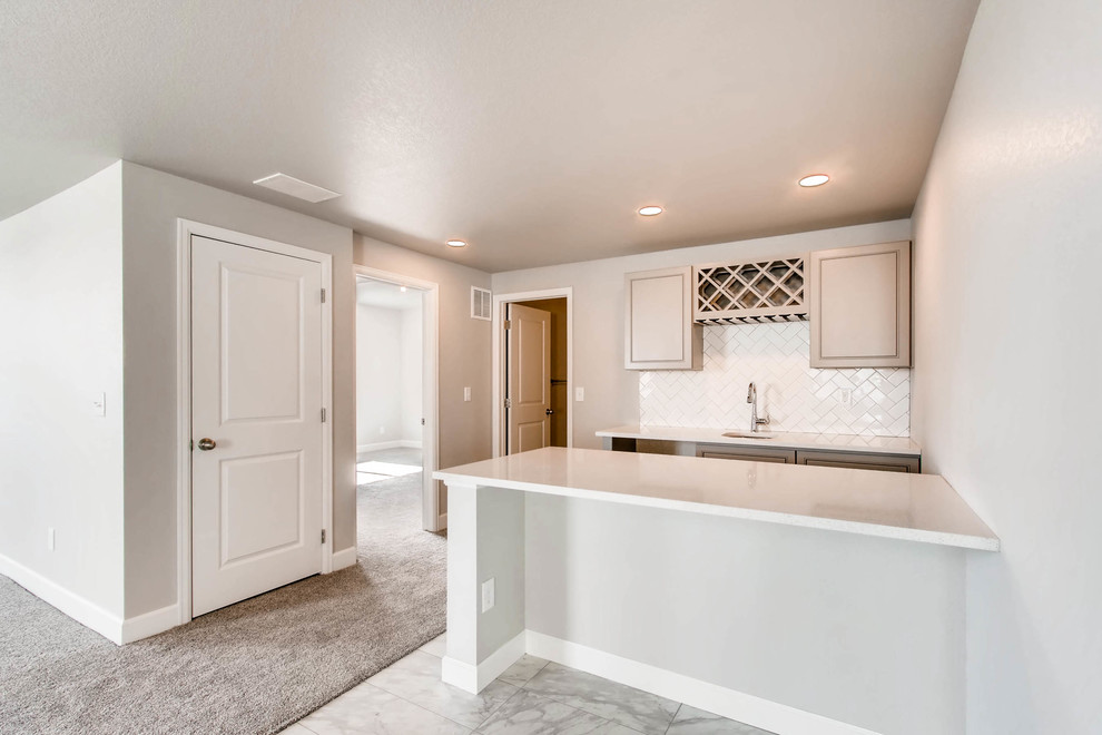 Inspiration for a large underground carpeted and gray floor basement remodel in Denver with gray walls and no fireplace