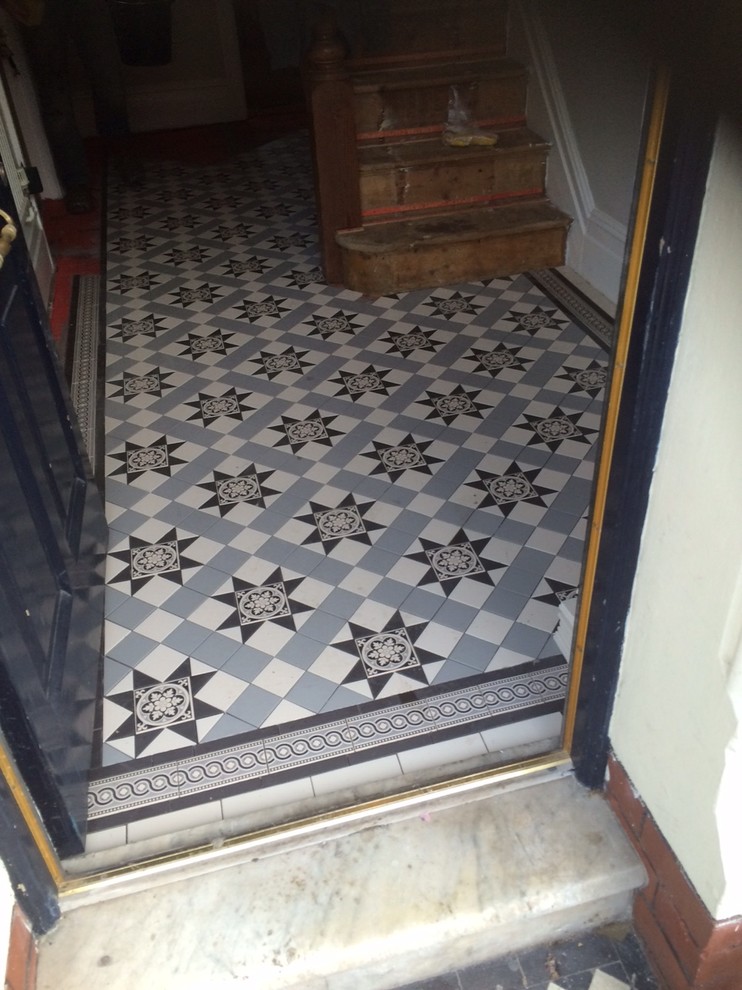 Mid-sized traditional hallway in Other with white walls and ceramic floors.