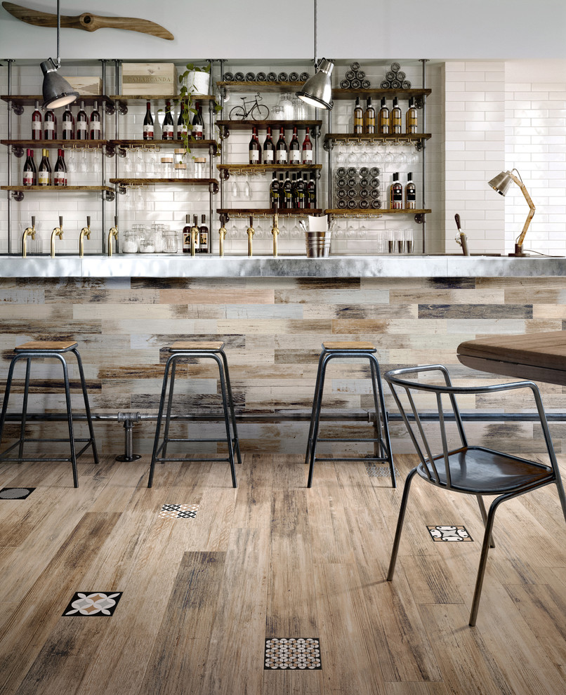 Inspiration for a modern single-wall seated home bar in Los Angeles with open cabinets, stainless steel benchtops, white splashback, porcelain splashback and porcelain floors.