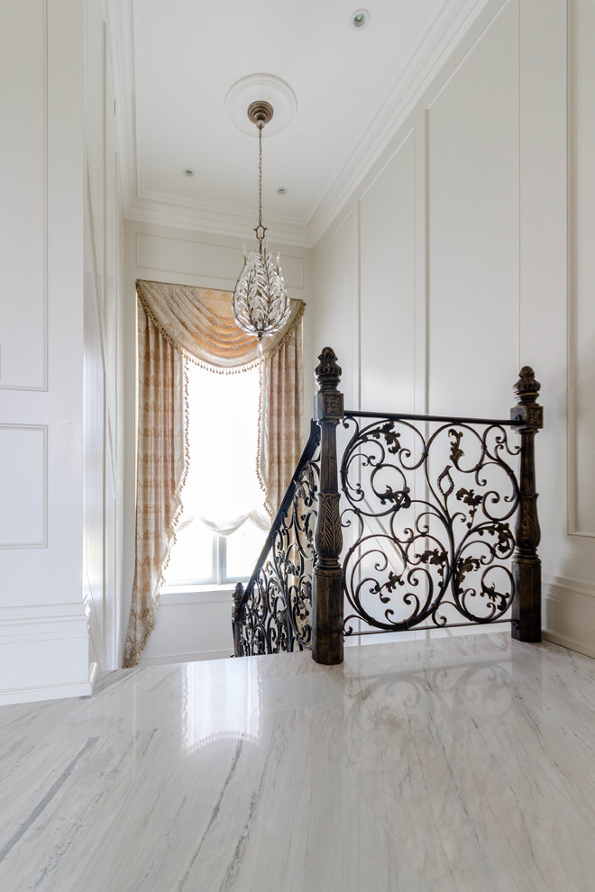 Large traditional hallway in Toronto with white walls, marble floors and grey floor.