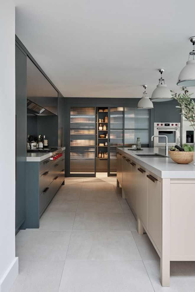 Design ideas for a contemporary kitchen in London with a submerged sink, flat-panel cabinets, grey cabinets, an island, beige floors and white worktops.