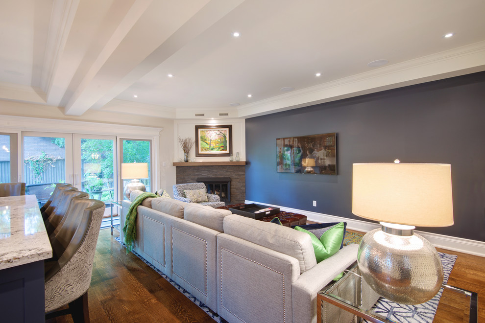 Mid-sized transitional open concept family room in Toronto with grey walls, medium hardwood floors, a corner fireplace, a stone fireplace surround and a wall-mounted tv.
