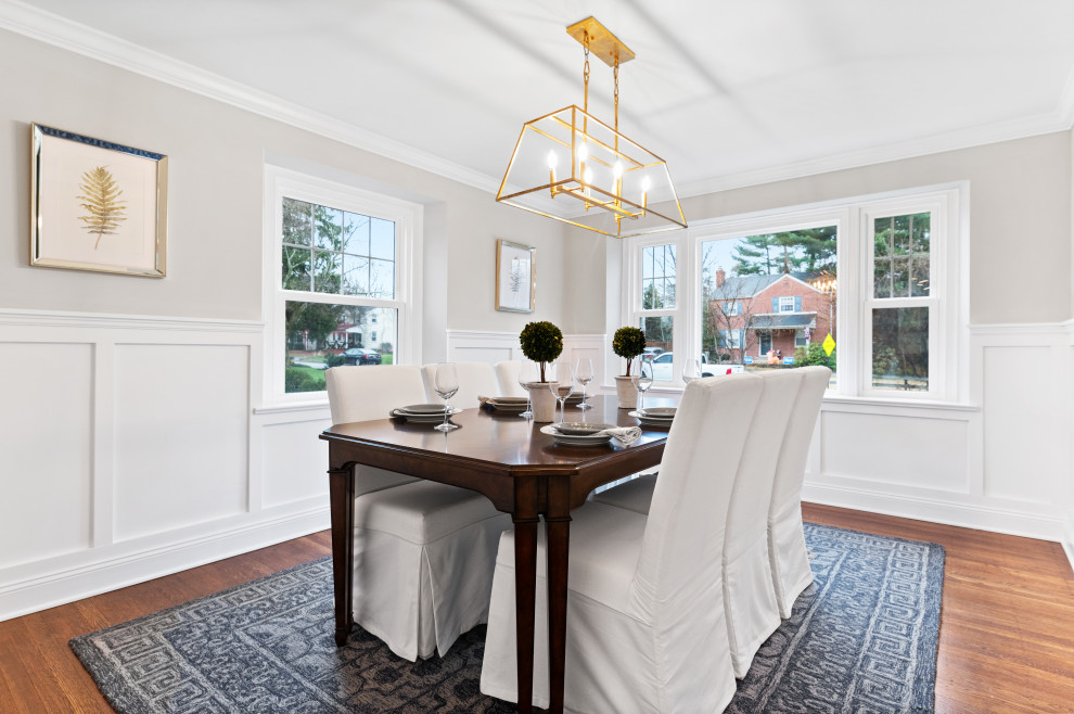 Inspiration for a mid-sized country separate dining room in Philadelphia with white walls, medium hardwood floors and decorative wall panelling.