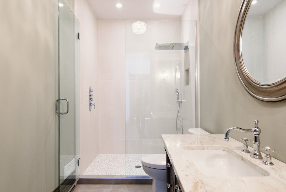 Design ideas for a small contemporary 3/4 bathroom in Montreal with an alcove shower, beige tile, porcelain tile, porcelain floors, an undermount sink, marble benchtops, flat-panel cabinets, dark wood cabinets, a one-piece toilet, beige walls, beige floor and a hinged shower door.
