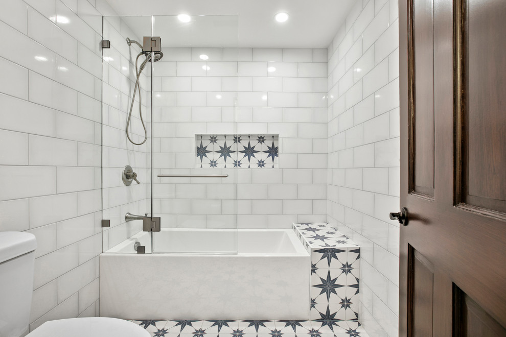 Photo of a large transitional kids bathroom in Los Angeles with shaker cabinets, blue cabinets, a freestanding tub, a shower/bathtub combo, white tile, porcelain tile, white walls, cement tiles, multi-coloured floor, a double vanity and a freestanding vanity.