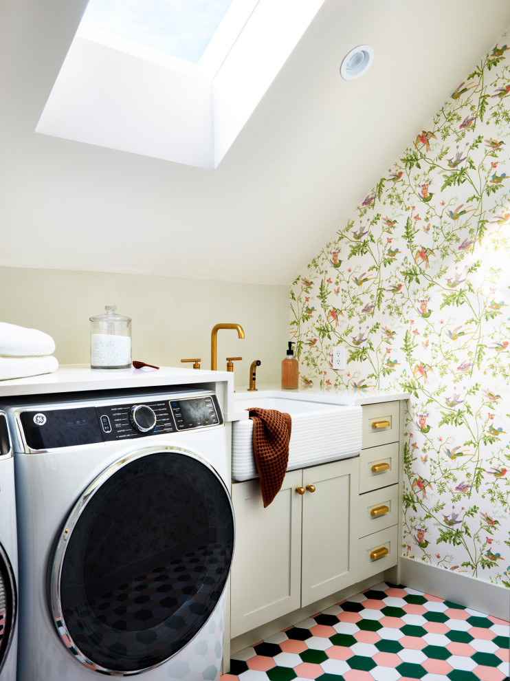Photo of a mid-sized traditional galley dedicated laundry room in Boston with shaker cabinets, beige cabinets, quartz benchtops, white walls, ceramic floors, a side-by-side washer and dryer, pink floor, white benchtop, vaulted and wallpaper.