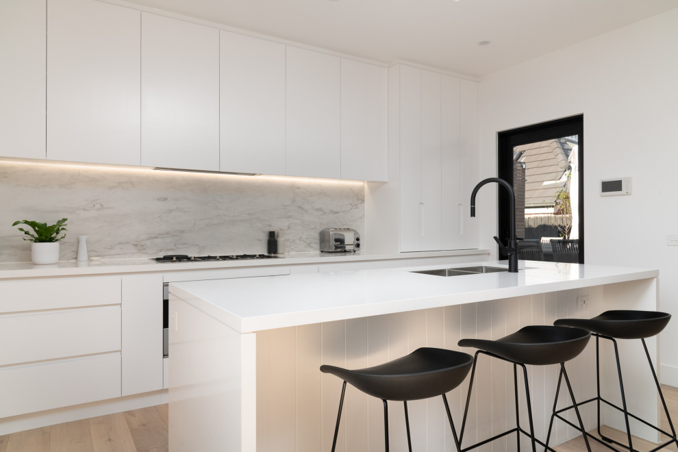 This is an example of a contemporary galley open plan kitchen in Melbourne with with island.