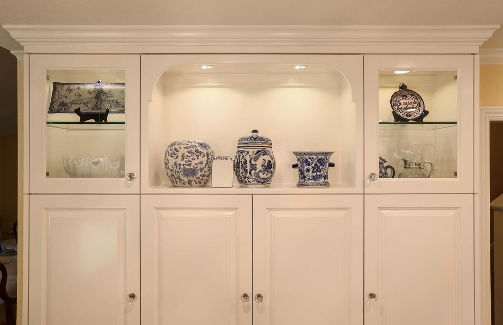 Example of a mid-sized transitional u-shaped light wood floor enclosed kitchen design in San Francisco with an undermount sink, beaded inset cabinets, white cabinets, marble countertops, white backsplash, subway tile backsplash, white appliances and an island