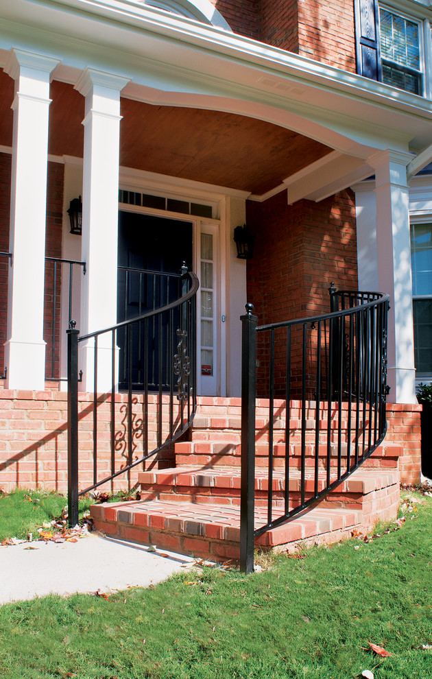 Inspiration for a large timeless brick front porch remodel in Atlanta with a roof extension
