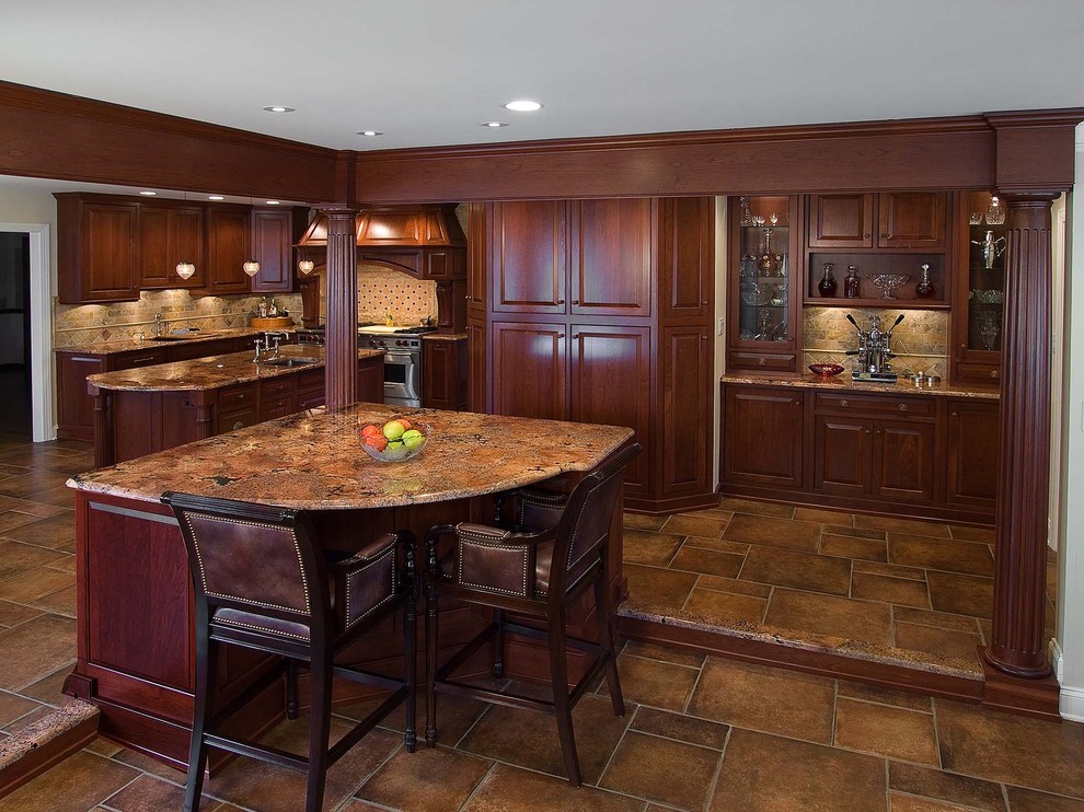 Inspiration for a traditional l-shaped eat-in kitchen in Philadelphia with beaded inset cabinets, medium wood cabinets, granite benchtops, stone tile splashback, stainless steel appliances, porcelain floors and multiple islands.