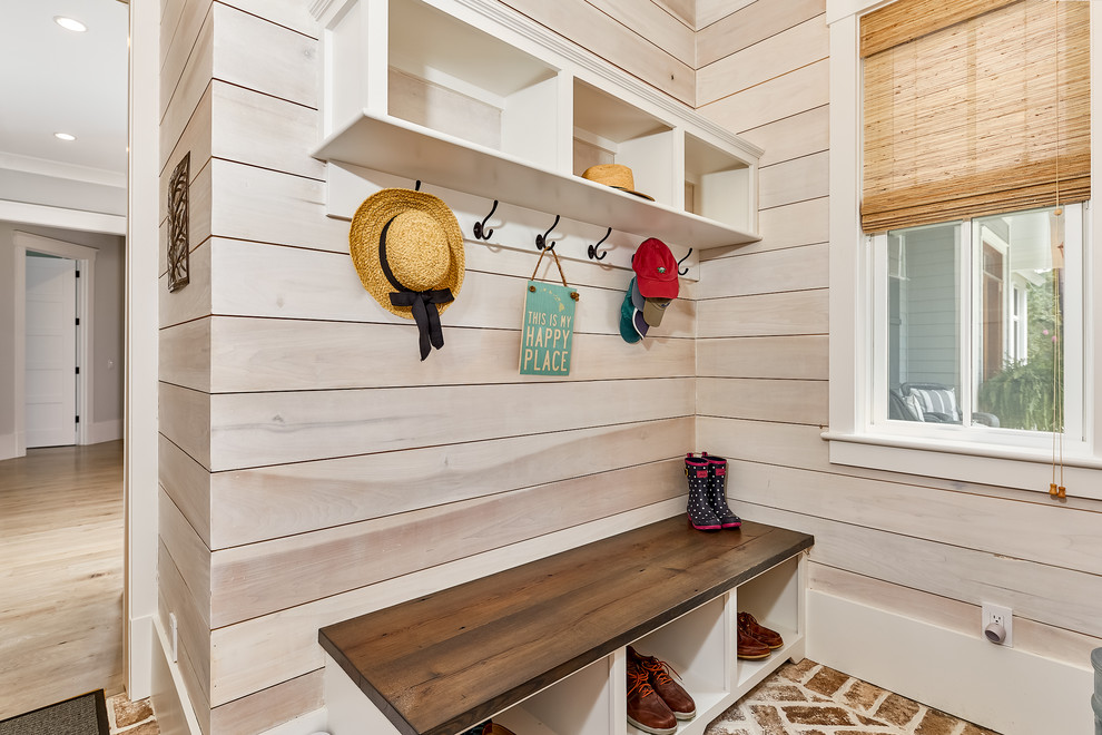 Mid-sized beach style mudroom in Charleston with beige floor.