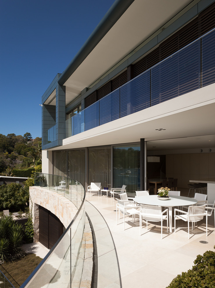 Inspiration for a contemporary balcony in Sydney with a roof extension.