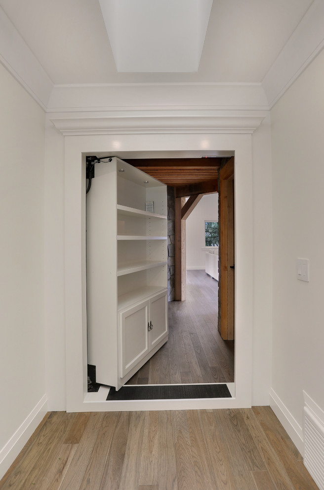 Mid-sized arts and crafts hallway in Vancouver with white walls, light hardwood floors and beige floor.