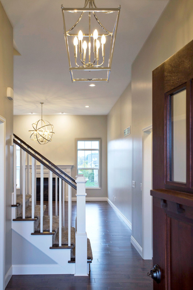 Inspiration for a mid-sized transitional medium tone wood floor foyer remodel in Chicago with gray walls and a dark wood front door