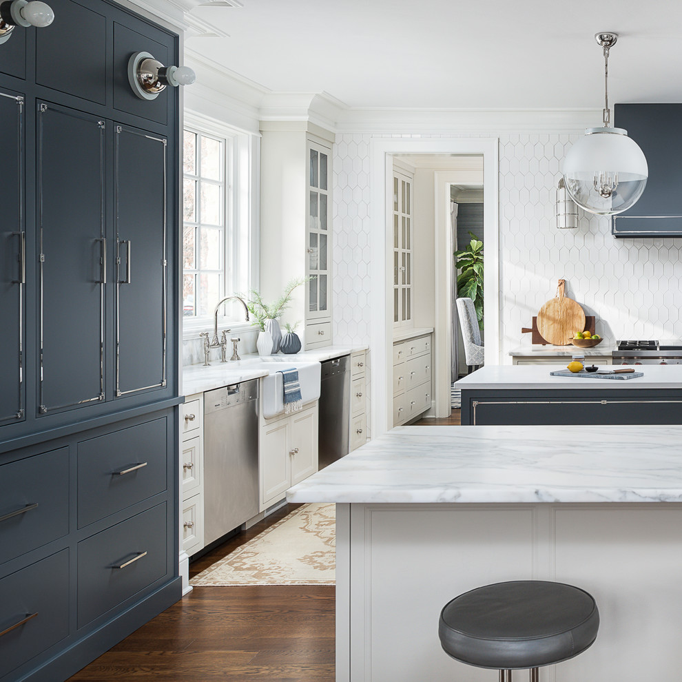Large transitional medium tone wood floor and brown floor kitchen photo in Chicago with a farmhouse sink, beaded inset cabinets, blue cabinets, marble countertops, white backsplash, ceramic backsplash, stainless steel appliances, two islands and yellow countertops