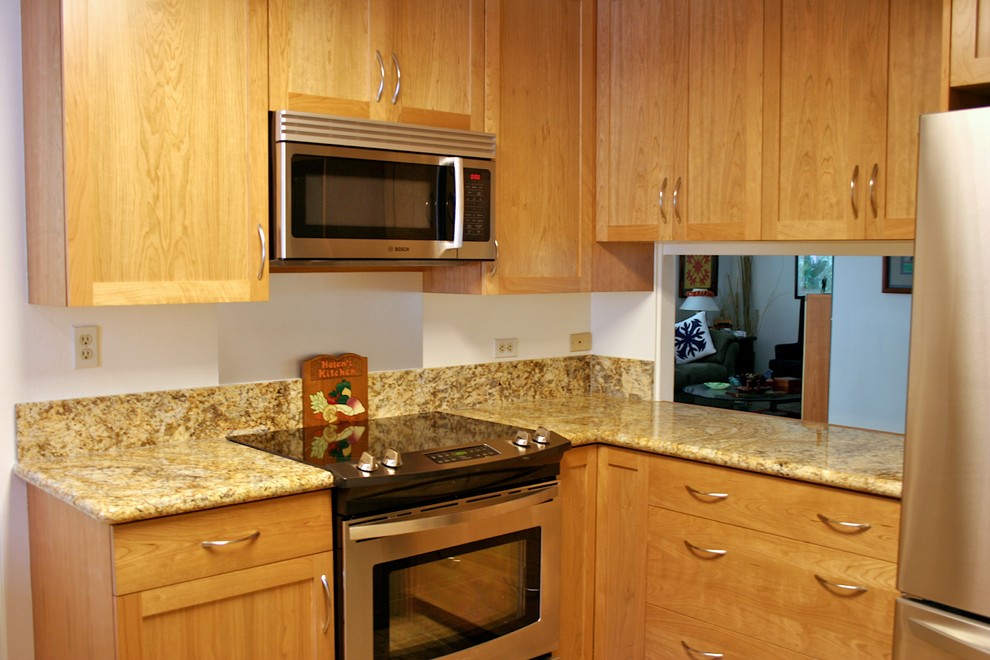 Example of a transitional kitchen design in Hawaii with an undermount sink, stainless steel appliances and white walls