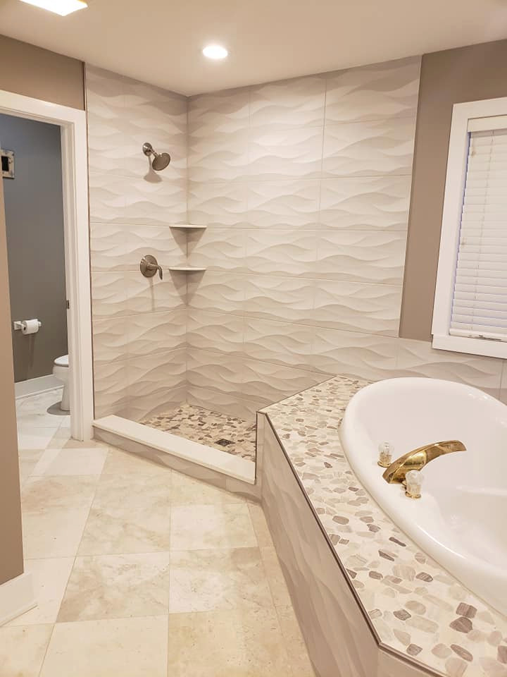 Photo of an expansive modern master bathroom in Chicago with a hot tub, a shower/bathtub combo, a one-piece toilet, beige tile, ceramic tile, white walls, ceramic floors, a drop-in sink, marble benchtops, beige floor, a shower curtain, white benchtops, a niche, a double vanity and a floating vanity.