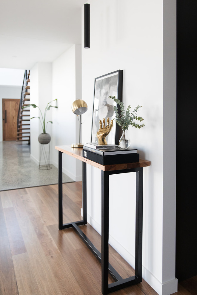 Design ideas for a mid-sized modern foyer in Canberra - Queanbeyan with white walls, medium hardwood floors, a single front door, a medium wood front door and brown floor.