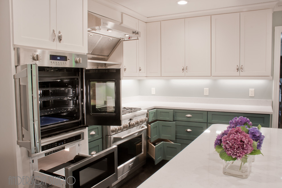 Small transitional galley dark wood floor and brown floor enclosed kitchen photo with a farmhouse sink, shaker cabinets, blue cabinets, quartz countertops, white backsplash, stainless steel appliances, an island and white countertops