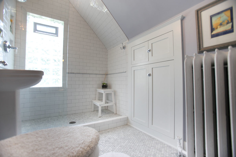 Photo of a mid-sized traditional 3/4 bathroom in Minneapolis with recessed-panel cabinets, white cabinets, an open shower, a two-piece toilet, gray tile, white tile, stone tile, purple walls, mosaic tile floors, a pedestal sink and solid surface benchtops.