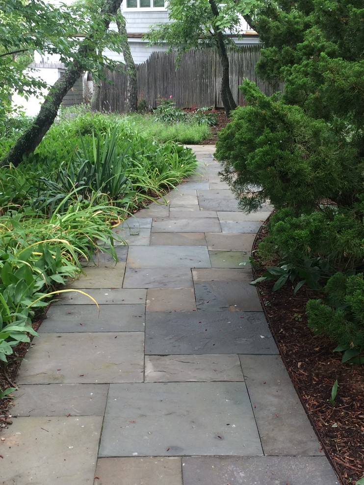 Inspiration for a small beach style front yard shaded driveway in New York with a garden path and natural stone pavers.