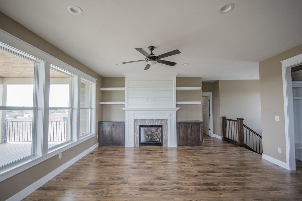 Example of a mountain style home design design with a tile fireplace