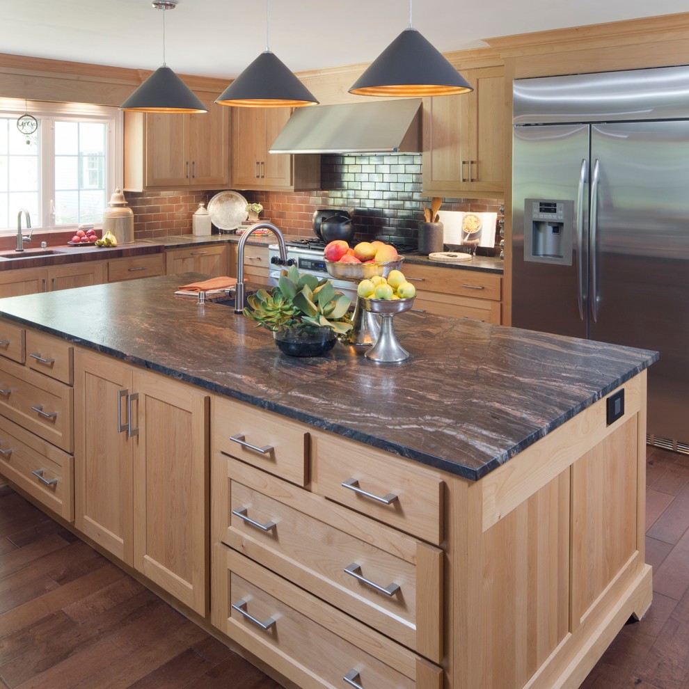 Example of a transitional medium tone wood floor kitchen design in Indianapolis with a drop-in sink, light wood cabinets, an island, brown backsplash and stone tile backsplash