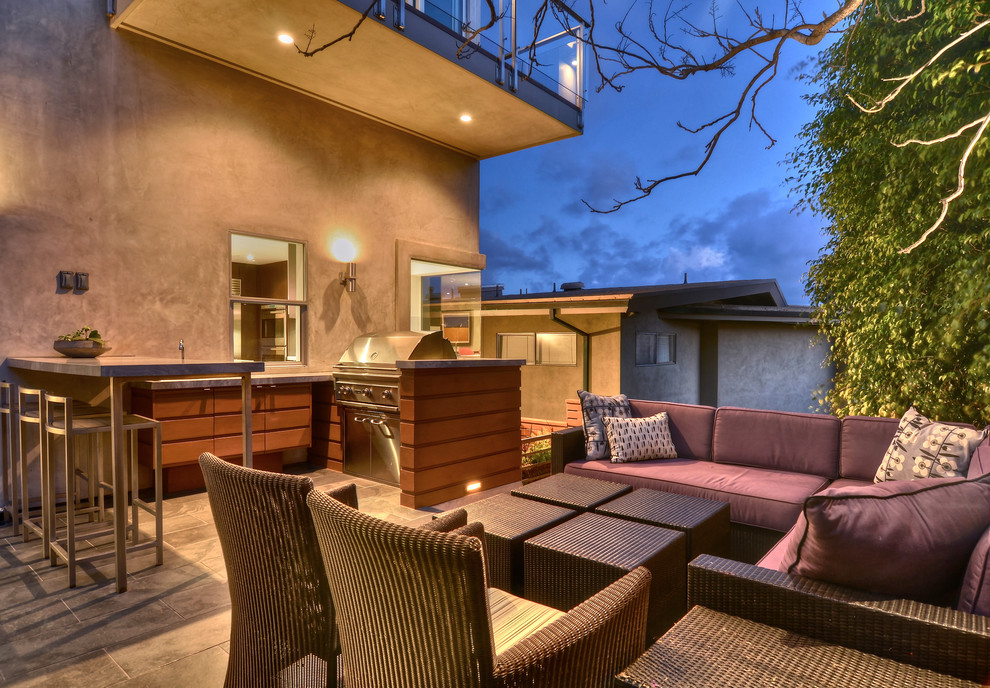 This is an example of a contemporary deck in Orange County with an outdoor kitchen and no cover.