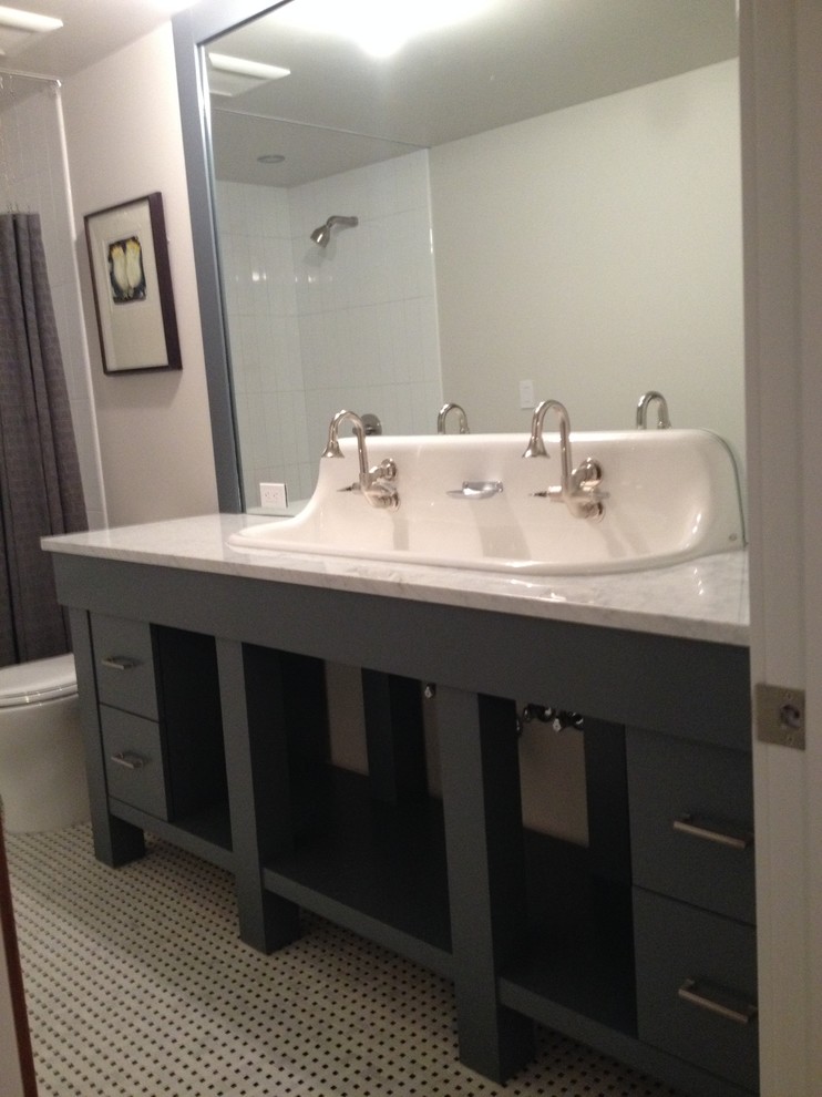 Design ideas for a mid-sized contemporary kids bathroom in Denver with grey cabinets, black and white tile, white walls, mosaic tile floors, a trough sink, quartzite benchtops, flat-panel cabinets, an alcove tub, a shower/bathtub combo, a one-piece toilet and porcelain tile.
