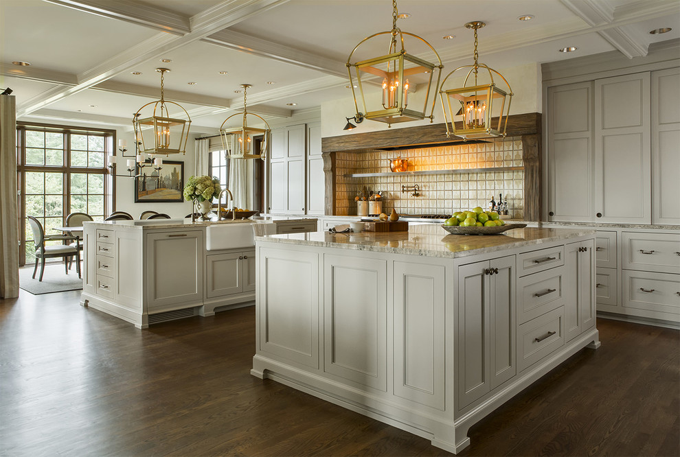 Inspiration for an expansive traditional kitchen in Portland with a farmhouse sink, recessed-panel cabinets, white cabinets, dark hardwood floors and multiple islands.