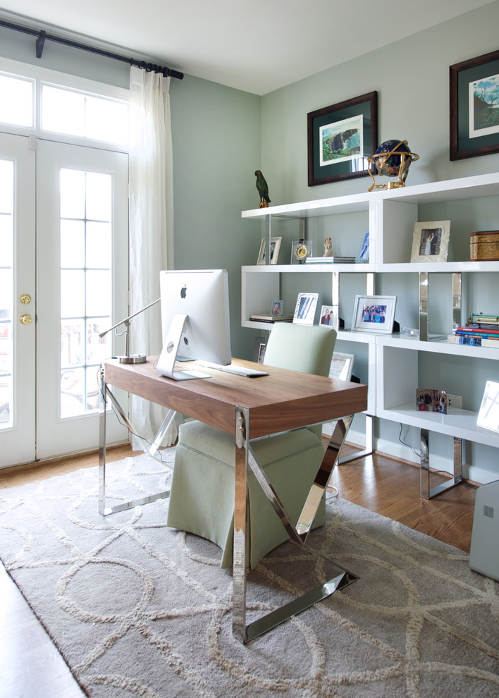 Mid-sized contemporary study room in DC Metro with medium hardwood floors, a freestanding desk, a two-sided fireplace, brown floor and grey walls.