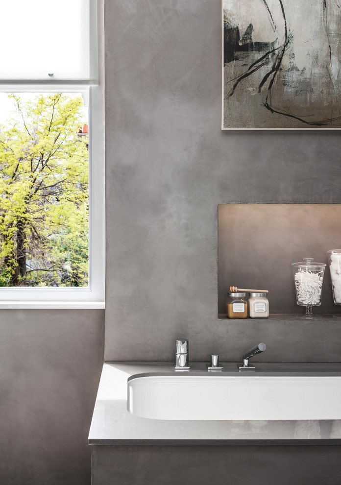Contemporary master bathroom in London with a drop-in tub, an open shower, gray tile and grey walls.