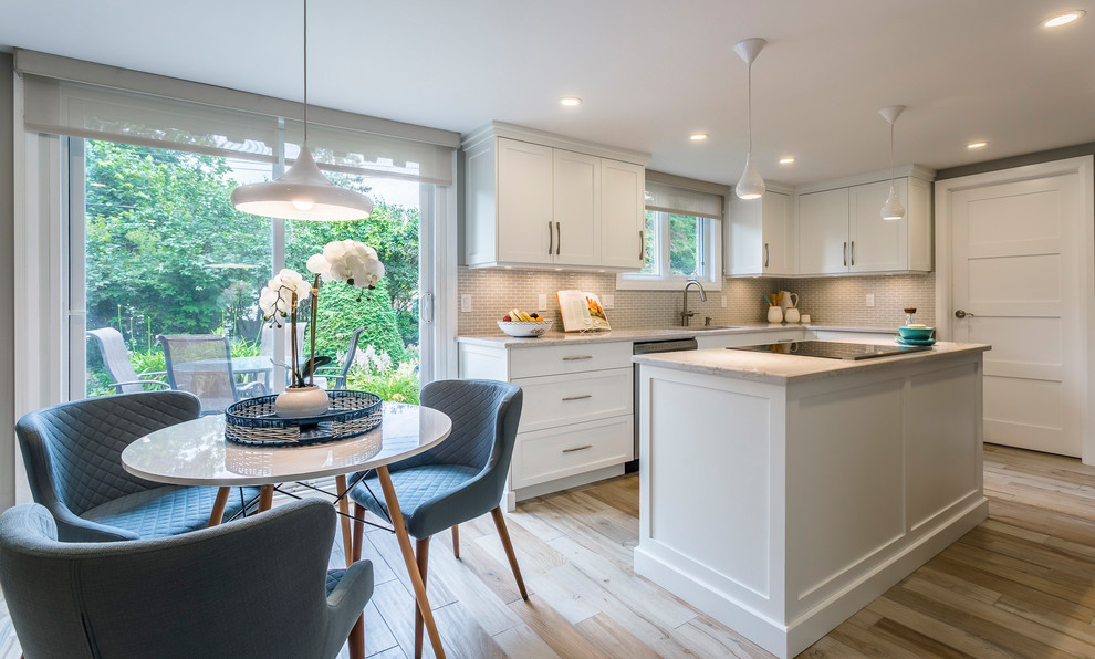 Inspiration for a mid-sized transitional l-shaped porcelain tile and beige floor eat-in kitchen remodel with an undermount sink, shaker cabinets, white cabinets, quartz countertops, gray backsplash, mosaic tile backsplash, stainless steel appliances and an island