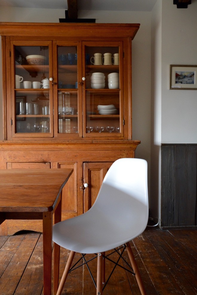 Mid-sized mountain style dark wood floor great room photo with white walls and no fireplace