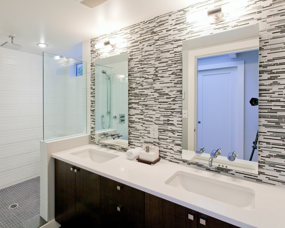 Photo of a mid-sized contemporary master bathroom in Vancouver with black cabinets, black tile, matchstick tile, an open shower, an open shower, white benchtops, flat-panel cabinets, white walls, mosaic tile floors, an undermount sink, engineered quartz benchtops and grey floor.