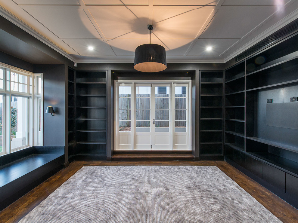 Inspiration for a large traditional home office in Brisbane with a library, black walls, carpet, a built-in desk and grey floor.