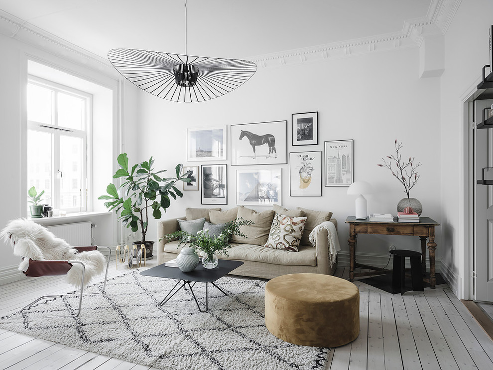 Scandinavian formal living room in Gothenburg with white walls, painted wood floors and white floor.