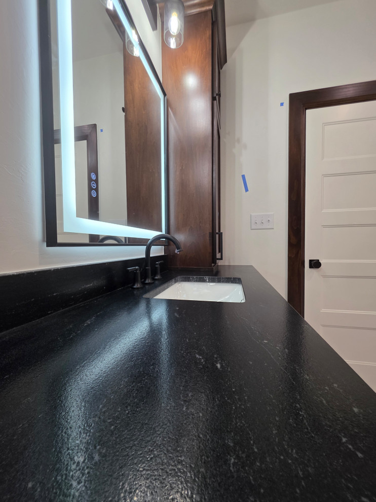 Dark countertops & wood finishes created a beautiful Primary/Master Bathroom