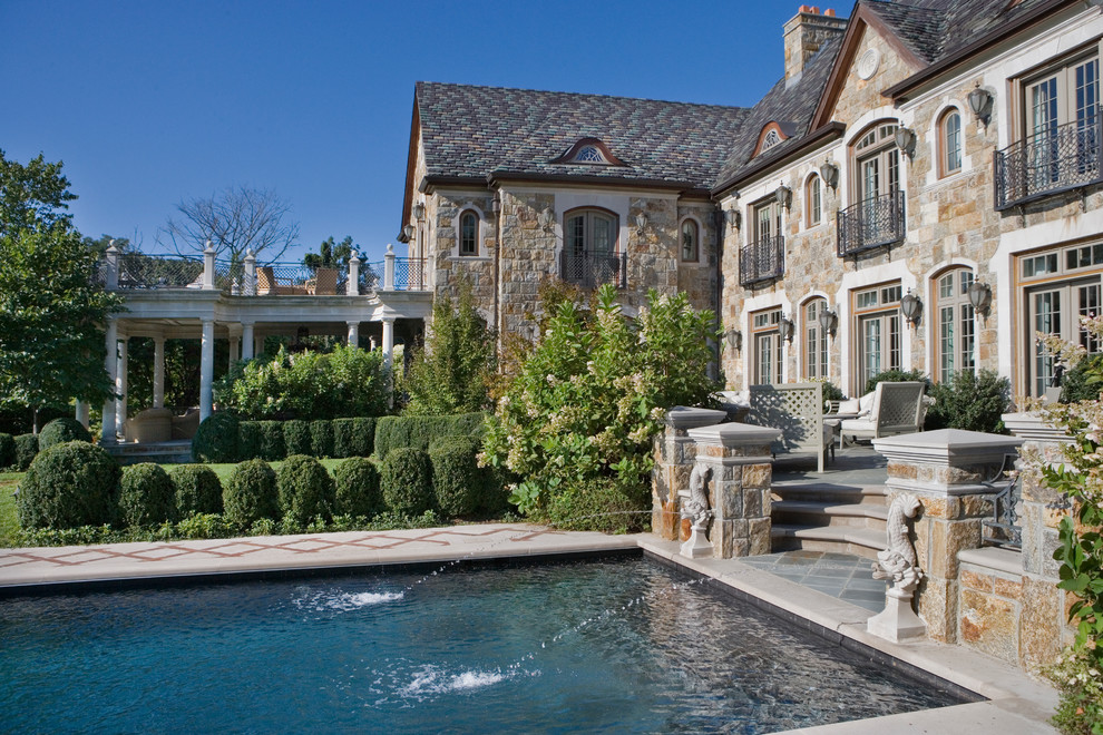 Photo of a traditional backyard rectangular pool in New York with natural stone pavers.