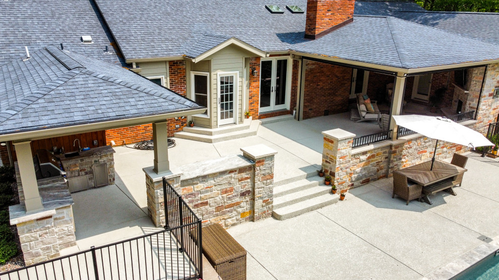 Covered Patio with an Outdoor Kitchen area and Fireplace Area Patio St Louis by Heartlands