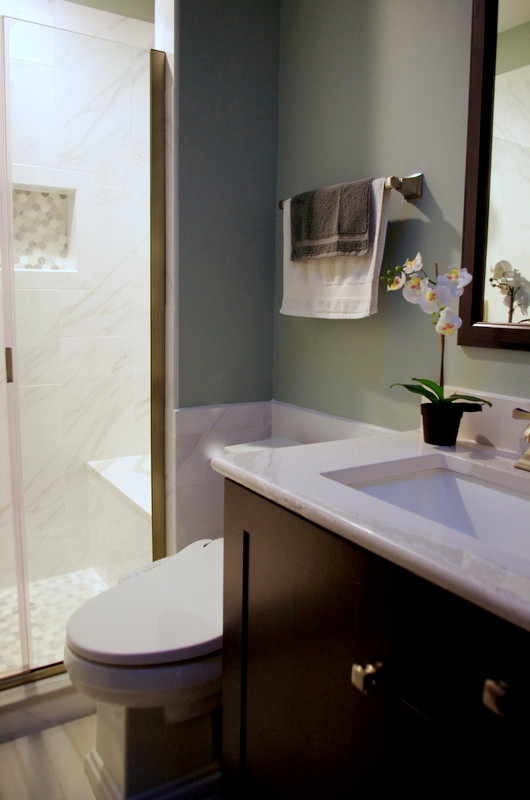 Example of a small transitional master gray tile and porcelain tile porcelain tile and brown floor alcove shower design in Chicago with shaker cabinets, dark wood cabinets, a one-piece toilet, gray walls, an undermount sink and quartz countertops
