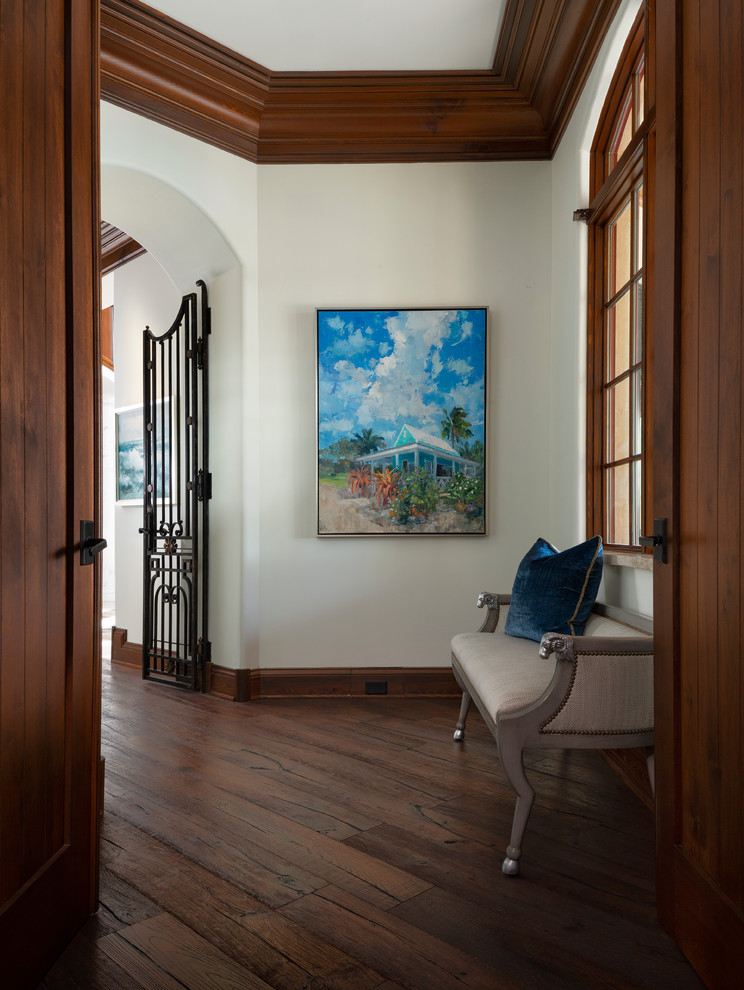 Transitional hallway in Miami with white walls, medium hardwood floors and brown floor.
